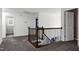 Upstairs hallway that features wood railings and access to other rooms at 2003 Pilot Mountain Ct, Apex, NC 27502