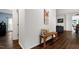 Hallway featuring hardwood flooring and a charming bench with decorative pillows at 2003 Pilot Mountain Ct, Apex, NC 27502