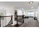 Open upstairs hallway with a cozy sitting area that's perfect for relaxing at 2003 Pilot Mountain Ct, Apex, NC 27502