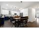 Open kitchen features stainless appliances, white cabinets, blue island, and adjacent dining area at 2003 Pilot Mountain Ct, Apex, NC 27502