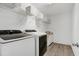 Bright laundry room featuring new washer and dryer and modern cabinets at 2003 Pilot Mountain Ct, Apex, NC 27502
