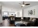 Open-concept living room featuring a large sectional sofa and views into the modern kitchen at 2003 Pilot Mountain Ct, Apex, NC 27502