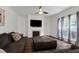 Living room showcasing a fireplace, large windows, and hardwood floors at 2003 Pilot Mountain Ct, Apex, NC 27502