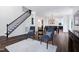 Cozy living room with gray chairs, modern decor, and hardwood floors at 2003 Pilot Mountain Ct, Apex, NC 27502