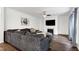 Inviting living room features a large sectional couch, fireplace, and television, ideal for relaxation at 2003 Pilot Mountain Ct, Apex, NC 27502