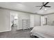 Bright primary bedroom showcasing a ceiling fan, adjacent bathroom, and natural light, offering a serene atmosphere at 2003 Pilot Mountain Ct, Apex, NC 27502