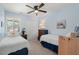 Inviting bedroom with twin beds, ceiling fan, and bright light, perfect for Gathering or guests at 202 Oak Tree Dr, Chapel Hill, NC 27517