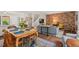 Open-concept living area featuring a dining table, exposed brick, a comfortable sofa, and hardwood floors at 202 Oak Tree Dr, Chapel Hill, NC 27517