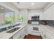 Bright kitchen featuring stainless sink, stainless appliances and white cabinets at 202 Oak Tree Dr, Chapel Hill, NC 27517