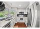 Well-lit kitchen with stainless steel appliances and white cabinets at 202 Oak Tree Dr, Chapel Hill, NC 27517
