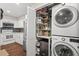 Laundry area with washer/dryer and storage space next to kitchen and refrigerator at 202 Oak Tree Dr, Chapel Hill, NC 27517