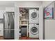 Convenient laundry area with washer/dryer and storage space next to kitchen and refrigerator at 202 Oak Tree Dr, Chapel Hill, NC 27517