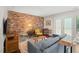 Bright living room featuring a comfortable sofa, a brick accent wall, hardwood floors, and natural light at 202 Oak Tree Dr, Chapel Hill, NC 27517