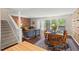 Bright living area with exposed brick, hardwood floors, open to the dining room at 202 Oak Tree Dr, Chapel Hill, NC 27517