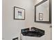 Corner powder room featuring marble countertop and mirror at 202 Oak Tree Dr, Chapel Hill, NC 27517