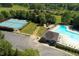 Aerial view of community pool, tennis courts, and playground, showcasing the recreational amenities available at 2030 Prairie Ridge Ct, Fuquay Varina, NC 27526
