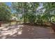Wide shot of deck surrounded by trees and lush landscaping in the backyard at 2030 Prairie Ridge Ct, Fuquay Varina, NC 27526