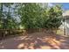 Spacious wooden deck with railing, surrounded by lush greenery and trees at 2030 Prairie Ridge Ct, Fuquay Varina, NC 27526