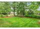 Lush backyard with green grass and a charming garden gate, perfect for outdoor relaxation and entertainment at 2030 Prairie Ridge Ct, Fuquay Varina, NC 27526