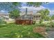 Backyard showcasing deck, screened-in porch, and lush landscaping at 2030 Prairie Ridge Ct, Fuquay Varina, NC 27526