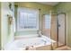 Bathroom features a soaking tub and glass-enclosed shower at 2030 Prairie Ridge Ct, Fuquay Varina, NC 27526