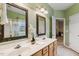 Well-lit bathroom with double vanity sinks and framed mirrors with tiled flooring at 2030 Prairie Ridge Ct, Fuquay Varina, NC 27526