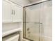 Bathroom featuring shower with sliding glass doors, toilet and built-in storage cabinet at 2030 Prairie Ridge Ct, Fuquay Varina, NC 27526