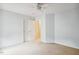 Bright bedroom featuring neutral walls and carpet, complemented by a ceiling fan and standard closet doors at 2030 Prairie Ridge Ct, Fuquay Varina, NC 27526