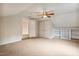 Spacious carpeted bedroom featuring built-in shelving and access to another room at 2030 Prairie Ridge Ct, Fuquay Varina, NC 27526
