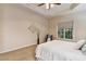 Bright bedroom features a tray ceiling, neutral tones, and a large window for natural light at 2030 Prairie Ridge Ct, Fuquay Varina, NC 27526