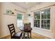 Bright breakfast nook features a round table, white flower centerpiece, and windows to the sunroom at 2030 Prairie Ridge Ct, Fuquay Varina, NC 27526