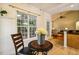 Charming breakfast nook with view to an open living area, featuring a round table and natural light at 2030 Prairie Ridge Ct, Fuquay Varina, NC 27526