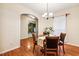 A dining room features a round wooden table, four chairs, and hardwood flooring at 2030 Prairie Ridge Ct, Fuquay Varina, NC 27526
