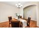 Warm dining room featuring a round table, chandelier, hardwood floors, and a neutral color palette at 2030 Prairie Ridge Ct, Fuquay Varina, NC 27526