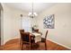 A dining room features a round wooden table, four chairs, and a decorative chandelier at 2030 Prairie Ridge Ct, Fuquay Varina, NC 27526