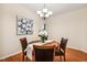 Inviting dining room features a round table, hardwood floors, modern chandelier, and neutral decor at 2030 Prairie Ridge Ct, Fuquay Varina, NC 27526