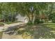 View of the side exterior with a long driveway leading to a two-car garage and partial lawn at 2030 Prairie Ridge Ct, Fuquay Varina, NC 27526