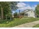 Home exterior featuring a screened porch, wooden deck, well-maintained lawn and landscaping, with mature trees at 2030 Prairie Ridge Ct, Fuquay Varina, NC 27526