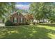 Brick home with well-maintained lawn and landscaping in a residential neighborhood at 2030 Prairie Ridge Ct, Fuquay Varina, NC 27526