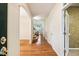Bright hallway with hardwood floors, arched entryway, and view of a staircase, creating an inviting space at 2030 Prairie Ridge Ct, Fuquay Varina, NC 27526