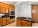 Well-equipped kitchen with wooden cabinets, granite countertops, and a built-in oven and microwave at 2030 Prairie Ridge Ct, Fuquay Varina, NC 27526