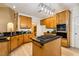 Modern kitchen featuring wood cabinets, granite countertops, stainless steel appliances and a central island at 2030 Prairie Ridge Ct, Fuquay Varina, NC 27526
