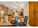 Open kitchen featuring wooden cabinets, black countertops, modern appliances, and a cozy dining area at 2030 Prairie Ridge Ct, Fuquay Varina, NC 27526