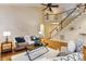 Spacious living room boasts a staircase, hardwood floors, high ceilings, and comfortable seating at 2030 Prairie Ridge Ct, Fuquay Varina, NC 27526