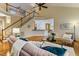 Open-concept living room boasts a staircase, hardwood floors, high ceilings and comfortable seating at 2030 Prairie Ridge Ct, Fuquay Varina, NC 27526