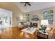 Elegant living room featuring a fireplace, hardwood floors, high ceilings, and abundant natural light at 2030 Prairie Ridge Ct, Fuquay Varina, NC 27526