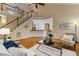 Spacious living room boasts hardwood floors, high ceilings, staircase and comfortable seating at 2030 Prairie Ridge Ct, Fuquay Varina, NC 27526