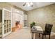 Office space with French doors, textured wallpaper, and a view into the dining area at 2030 Prairie Ridge Ct, Fuquay Varina, NC 27526