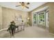 Office featuring a large bay window, carpet, ceiling fan and decorated desk with chair at 2030 Prairie Ridge Ct, Fuquay Varina, NC 27526
