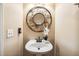 Stylish powder room featuring a pedestal sink with decorative mirror and modern fixtures at 2030 Prairie Ridge Ct, Fuquay Varina, NC 27526